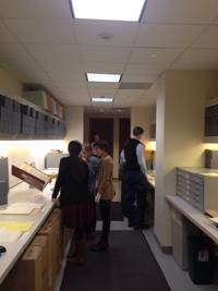 Librarian, Elaina Vitale discussing some rare books with building coworkers.